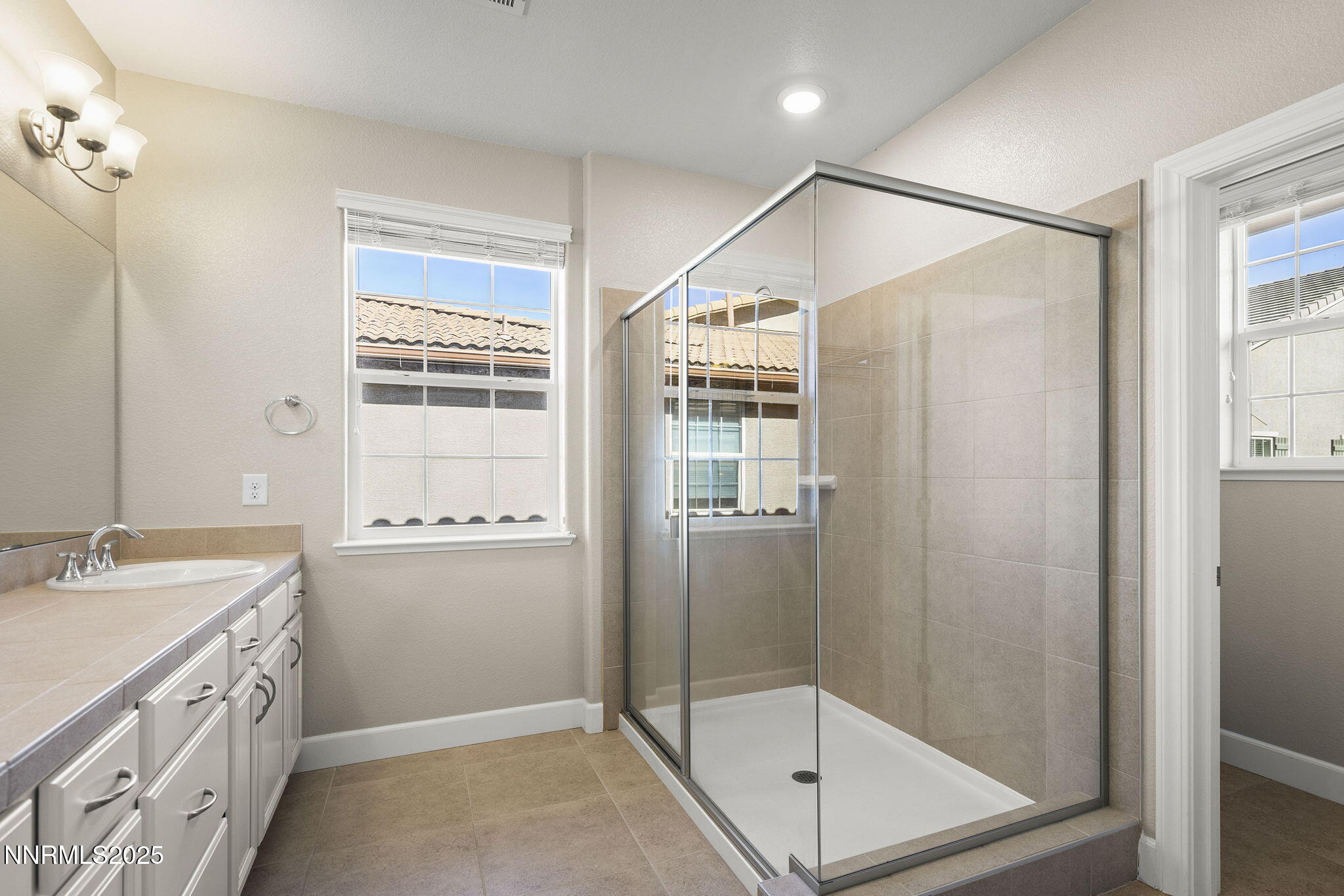 1875 Sea Horse Road, Unit C Reno, NV 89521 - Photo 21 of 39 a bathroom with a shower sink and mirror