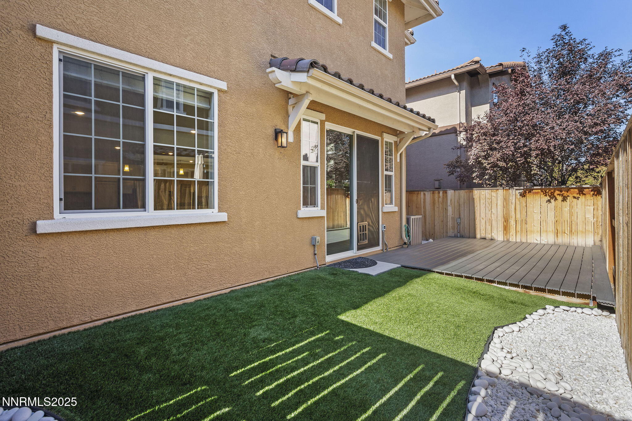 1875 Sea Horse Road, Unit C Reno, NV 89521 - Photo 29 of 39 a view of a backyard with table and chairs and wooden fence