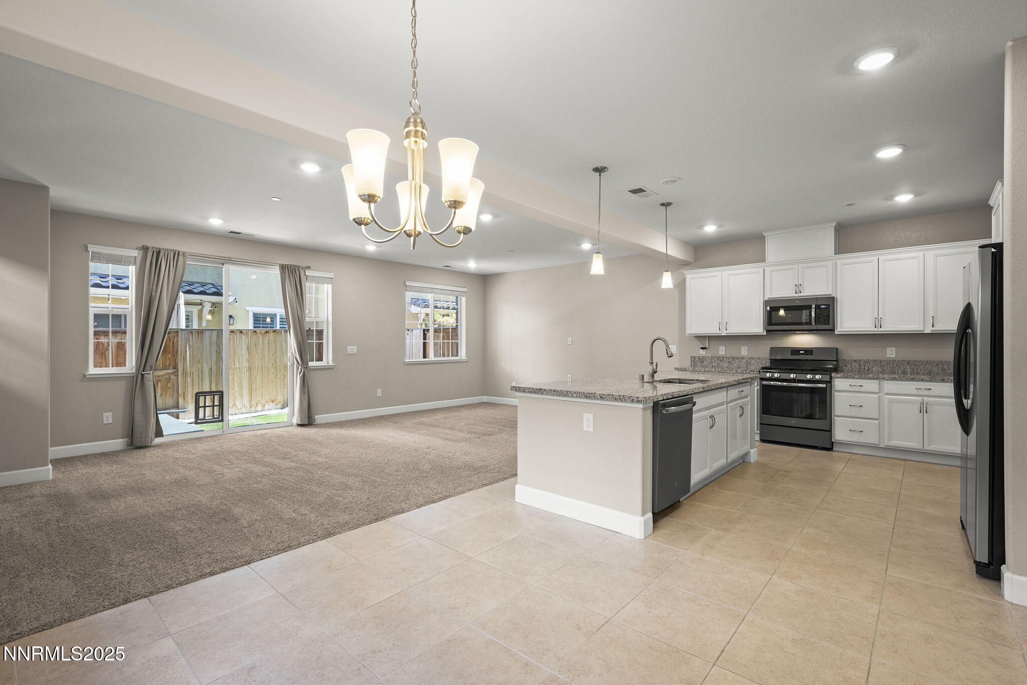 1875 Sea Horse Road, Unit C Reno, NV 89521 - Photo 4 of 39 a large kitchen with kitchen island a large counter top stainless steel appliances and cabinets