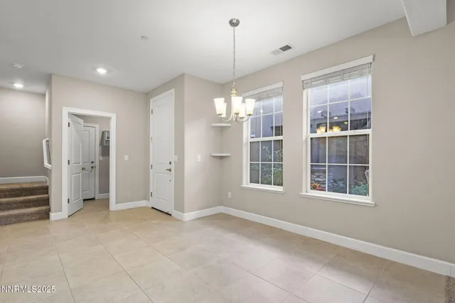 a large kitchen with granite countertop a large counter top appliances and cabinets