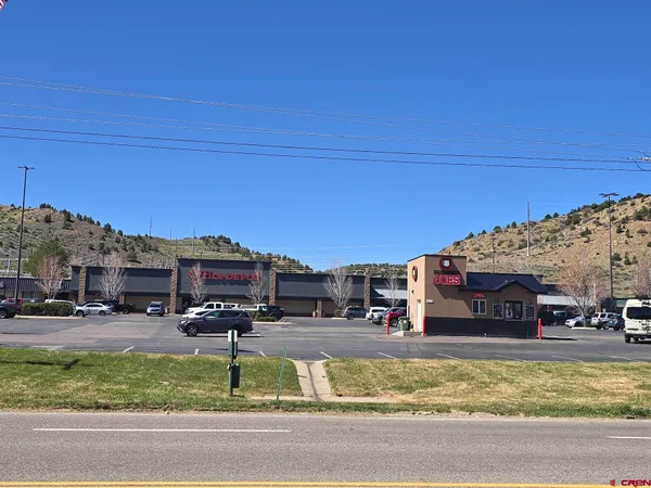 a view of building with cars parked