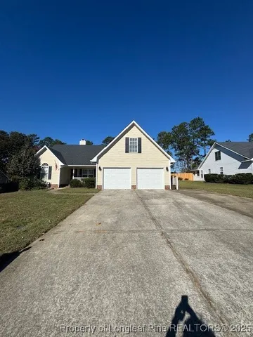 a view of a house with a yard and garage