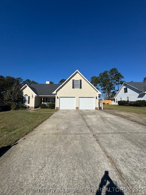 a view of a house with a yard and garage