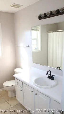 a bathroom with a sink toilet a mirror and shower