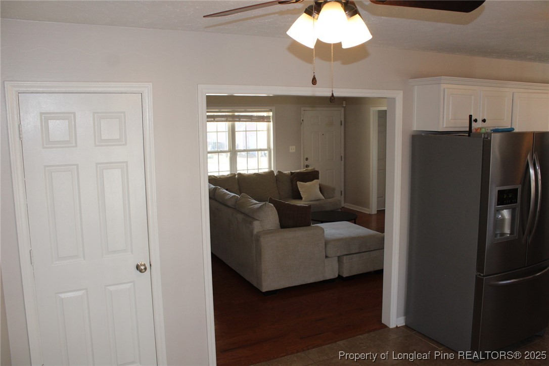 209 Dolphin Drive Raeford, NC 28376 - Photo 27 of 30 a living room with furniture a chandelier and a refrigerator
