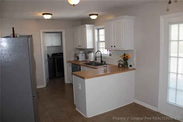 a kitchen that has a lot of cabinets in it and appliances