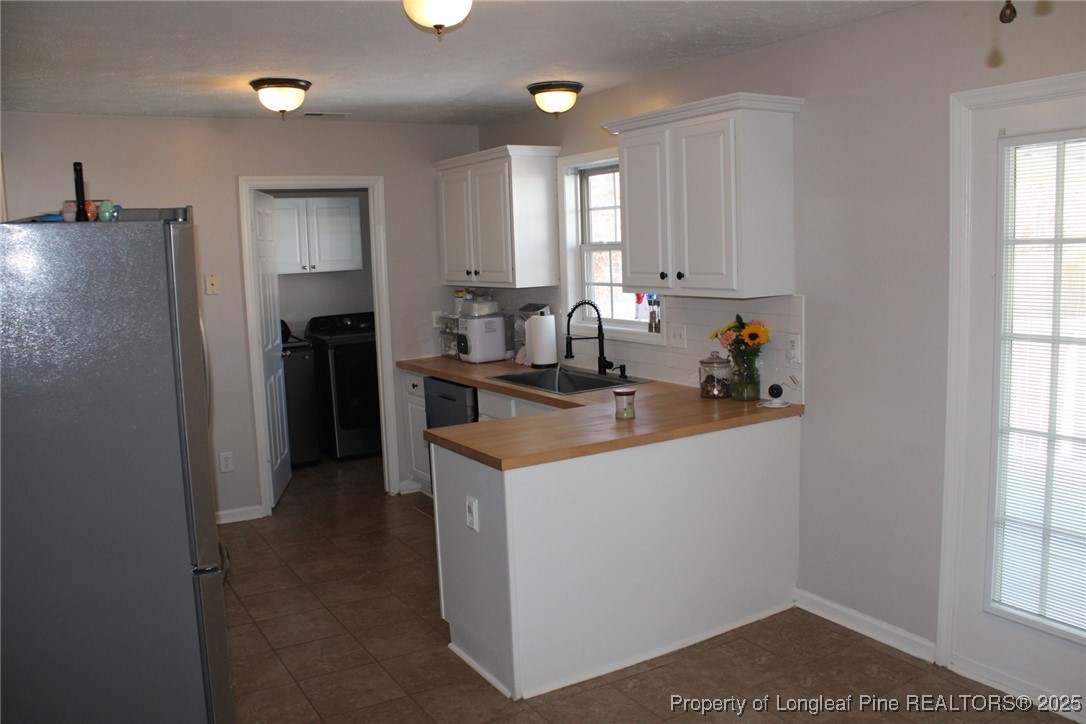 209 Dolphin Drive Raeford, NC 28376 - Photo 29 of 30 a kitchen that has a lot of cabinets in it and appliances