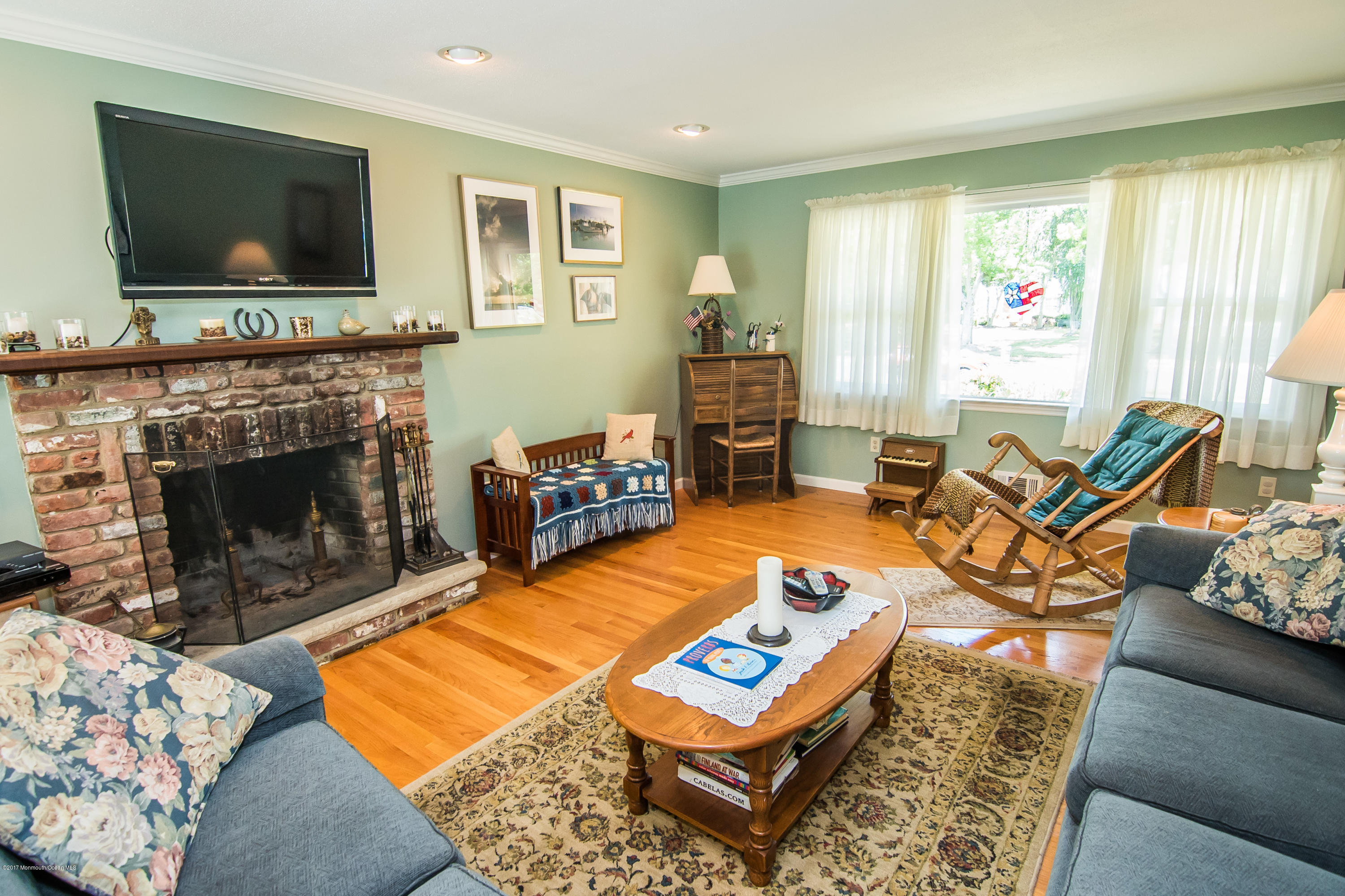 22 Old Post Road Freehold, NJ 07728 - Photo 15 of 61 a living room with furniture a flat screen tv and a fireplace