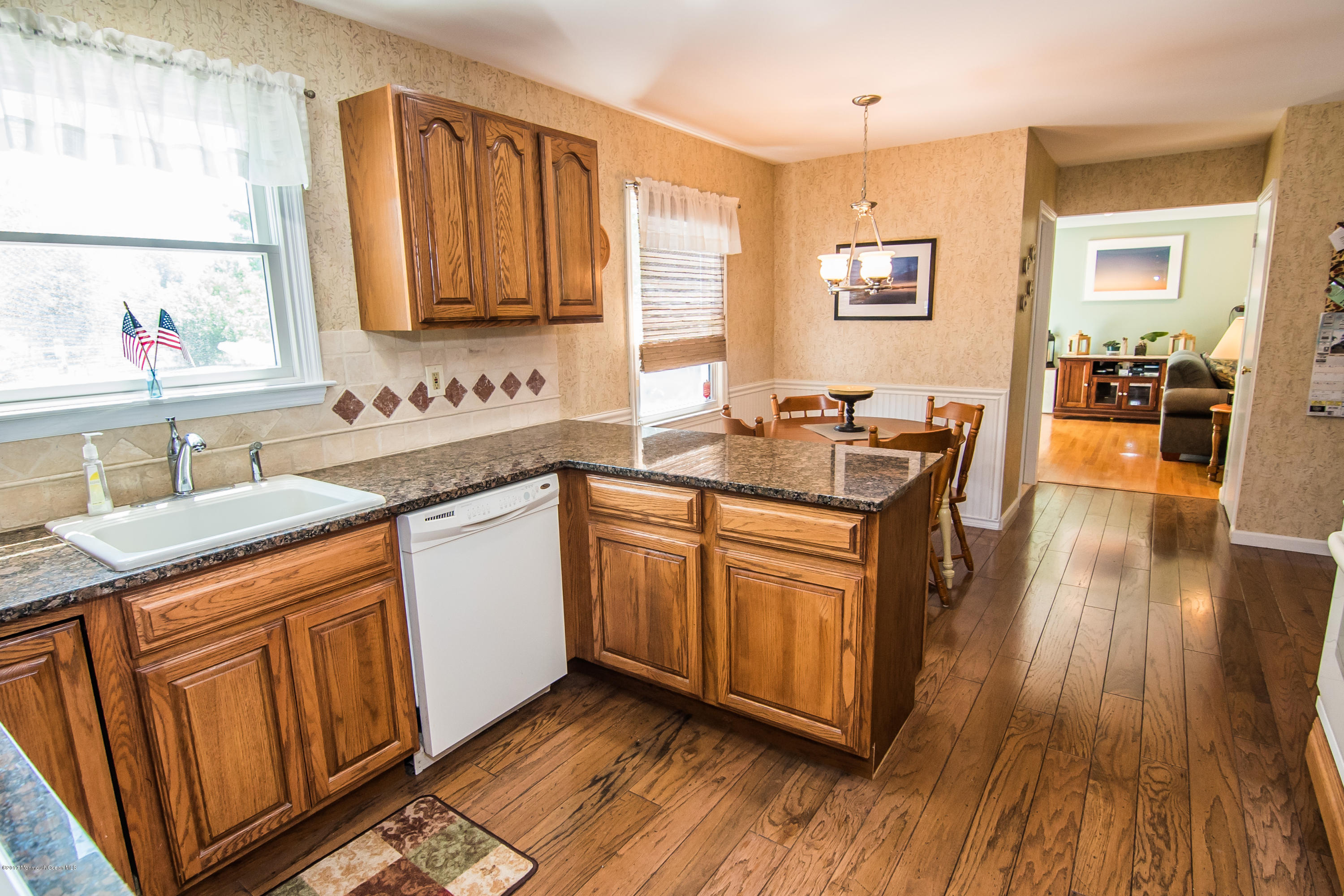 22 Old Post Road Freehold, NJ 07728 - Photo 19 of 61 a kitchen with stainless steel appliances granite countertop wooden floors and sink