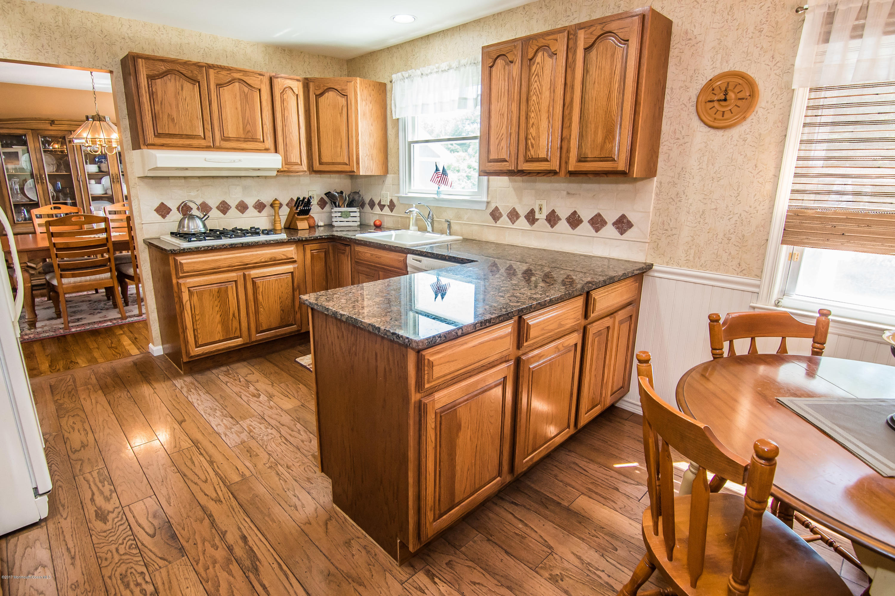 22 Old Post Road Freehold, NJ 07728 - Photo 21 of 61 a kitchen with stainless steel appliances granite countertop a stove a sink dishwasher and a refrigerator with wooden floor