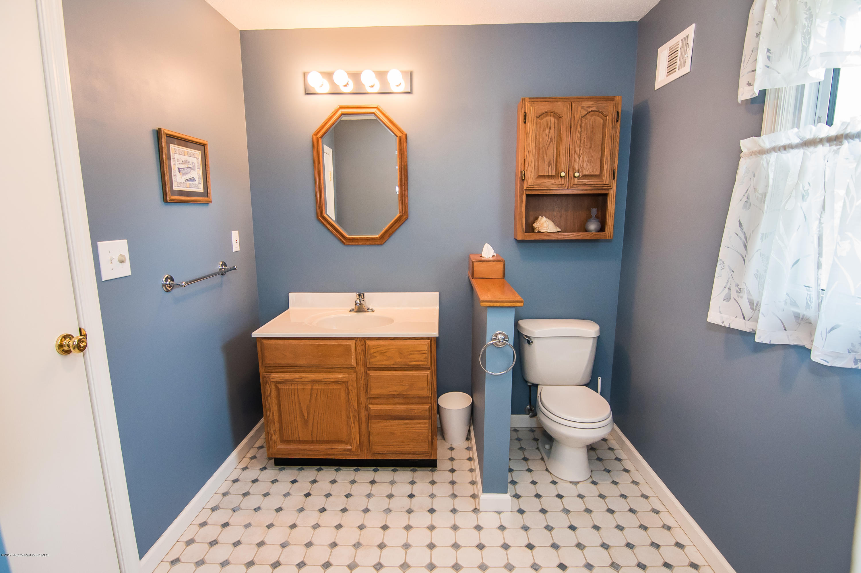22 Old Post Road Freehold, NJ 07728 - Photo 32 of 61 a bathroom with a toilet a sink and a mirror