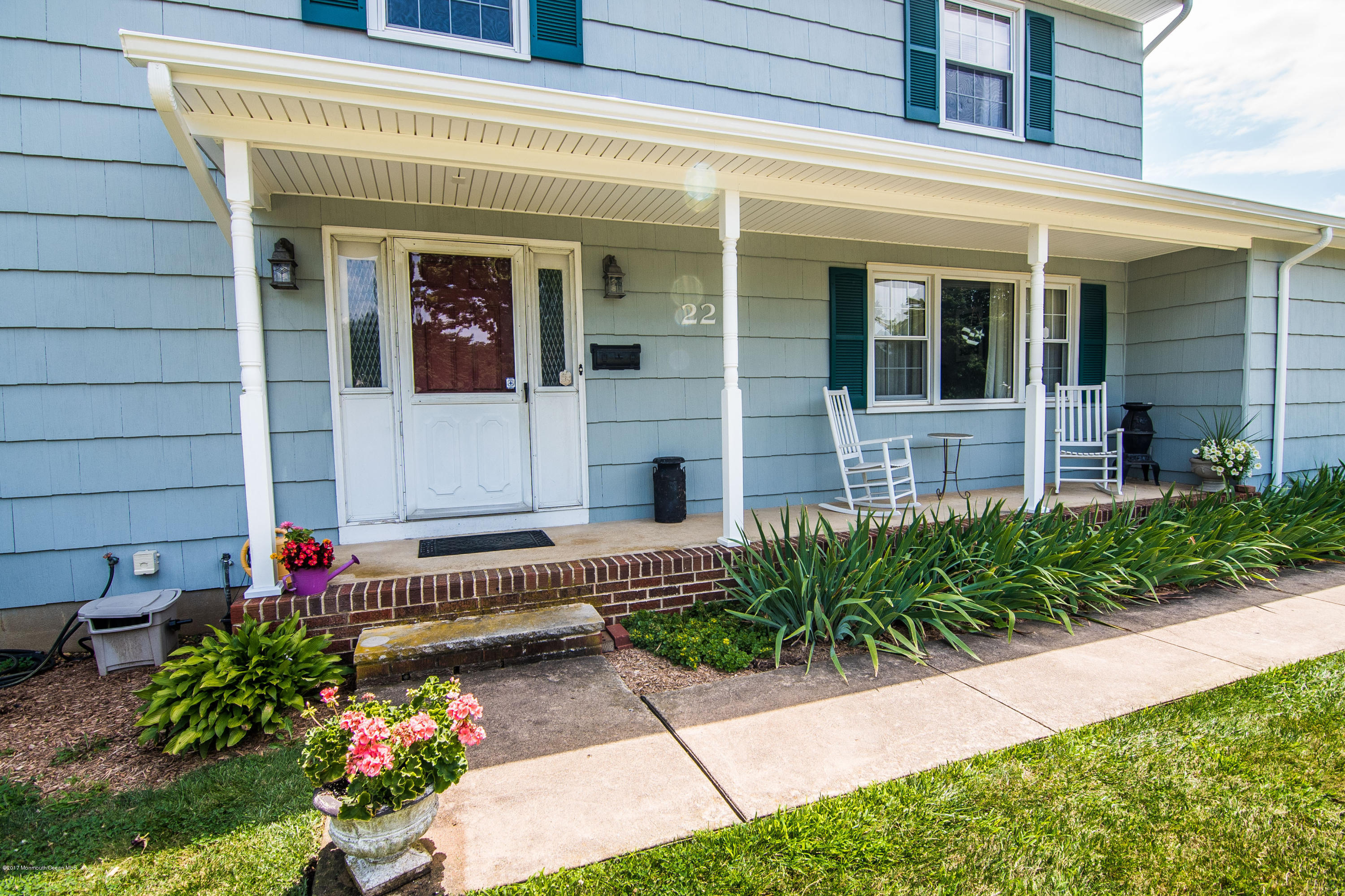 22 Old Post Road Freehold, NJ 07728 - Photo 39 of 61 a front view of a house with a yard and flowers
