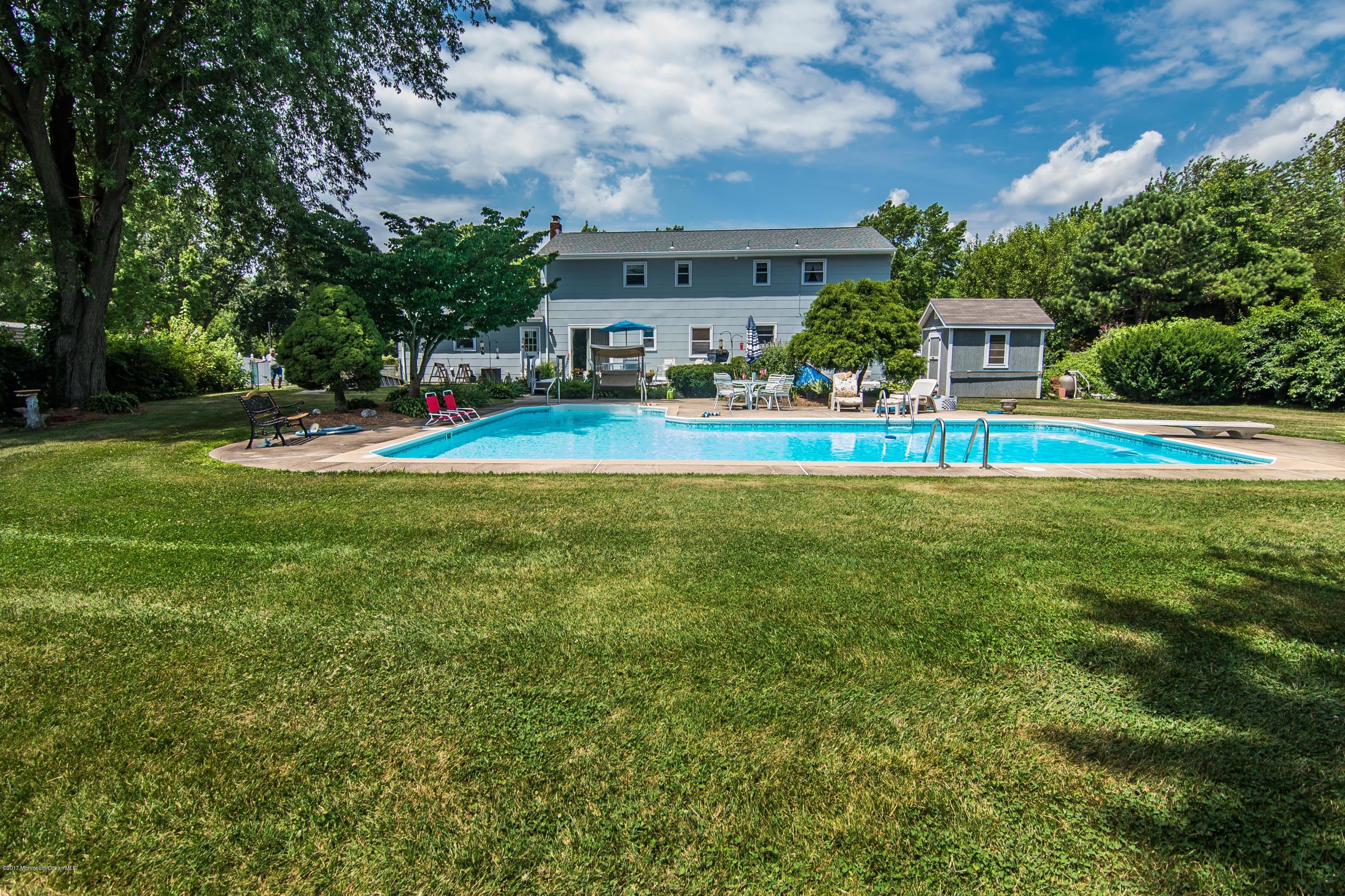 22 Old Post Road Freehold, NJ 07728 - Photo 53 of 61 a front view of a house with swimming pool garden and trees