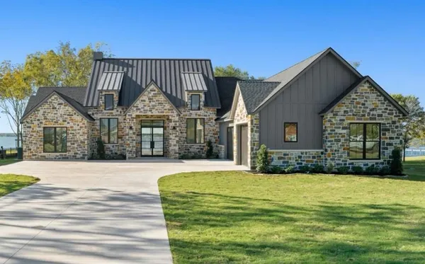 a front view of house with yard and green space