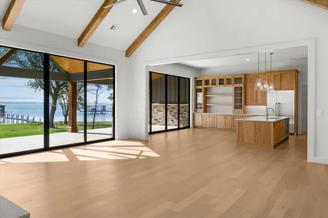 a view of an empty room with a fireplace and a large window