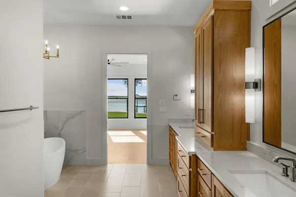 a bathroom with a tub sink and mirror