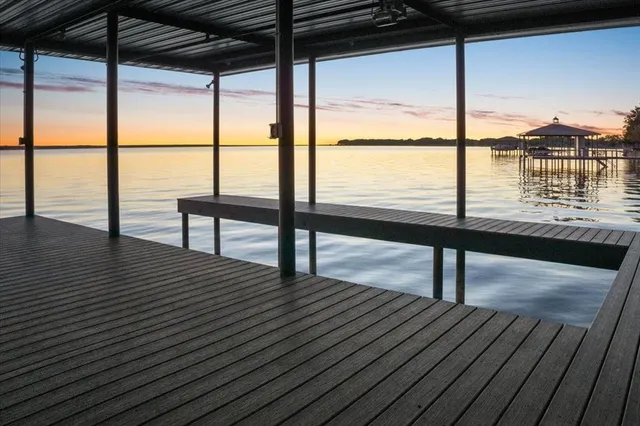 a view of a room with wooden floor and furniture