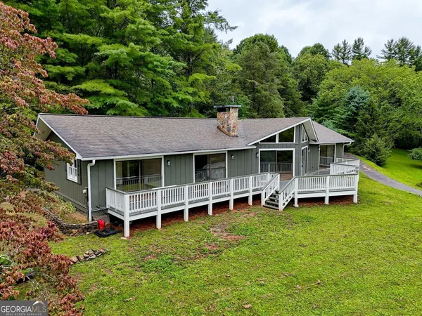 an aerial view of a house with a garden and deck