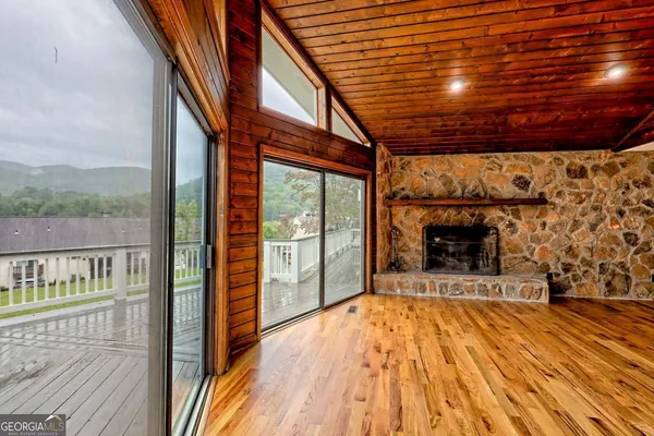 a large kitchen with kitchen island a large window in it