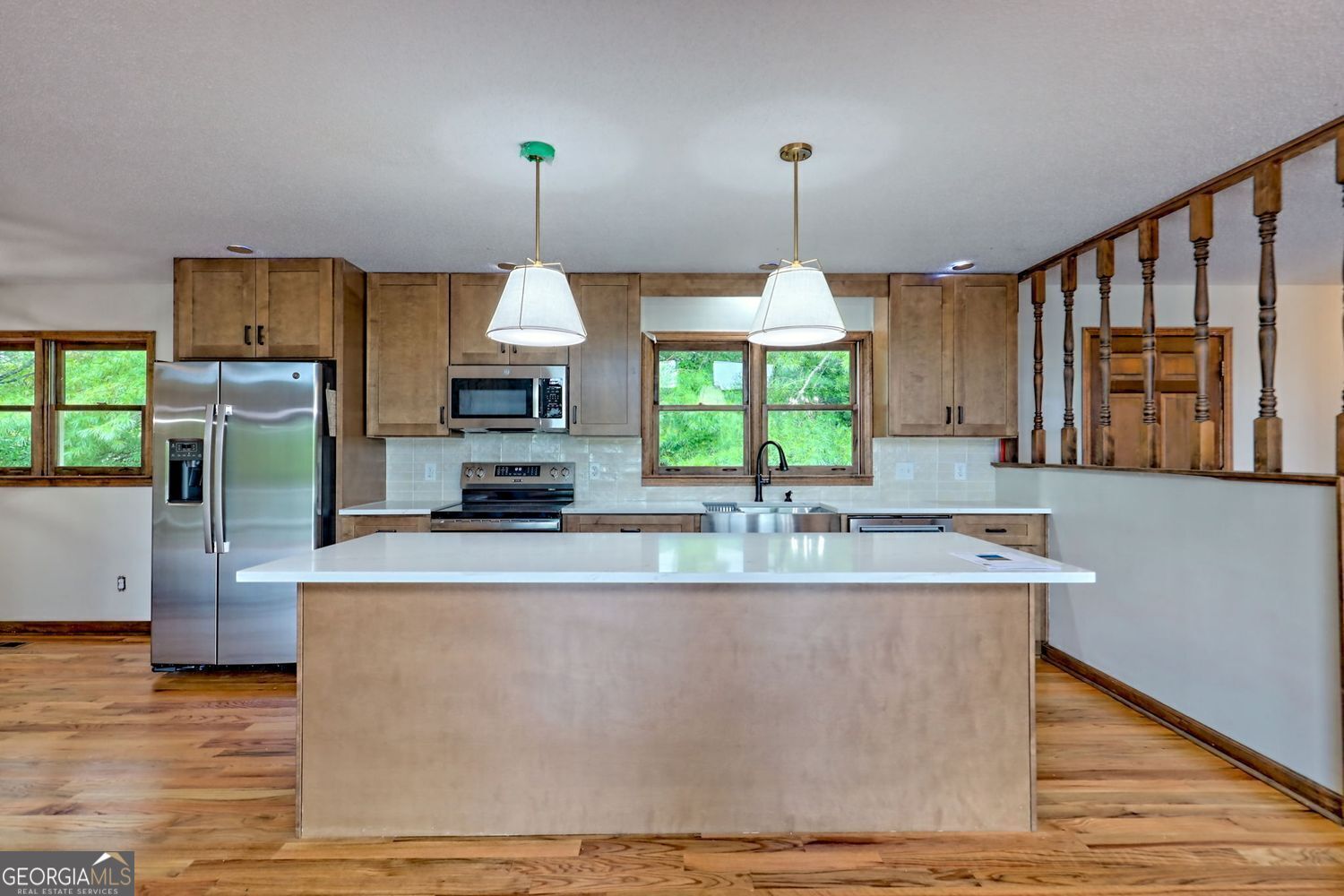 156 Tahoe Lane Dillard, GA 30537 - Photo 15 of 76 a kitchen with kitchen island granite countertop a stove a sink a center island and wooden floor