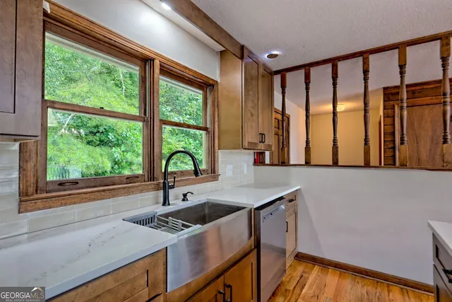 a bathroom with a sink a light fixture and a mirror
