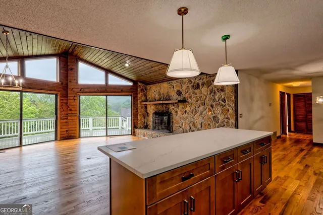 a view of a kitchen with wooden floor and a kitchen
