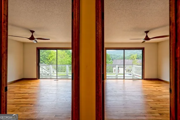 a bathroom with a granite countertop toilet a sink a mirror and a window