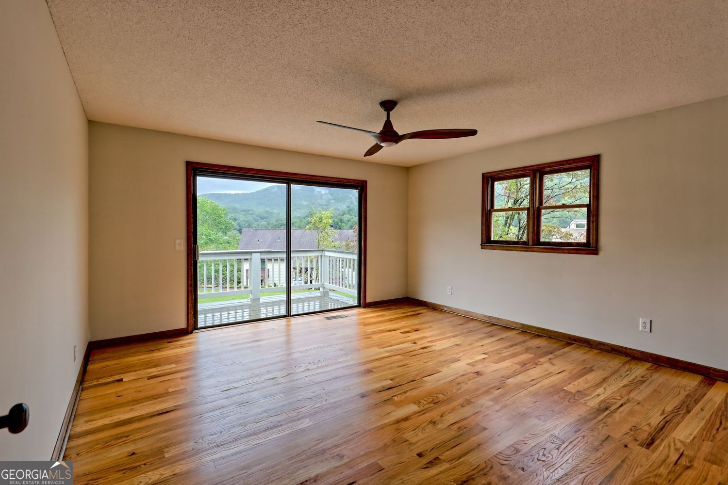 156 Tahoe Lane Dillard, GA 30537 - Photo 30 of 76 a view of an empty room with wooden floor and a window
