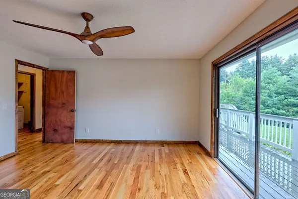 a balcony with wooden floor and city view