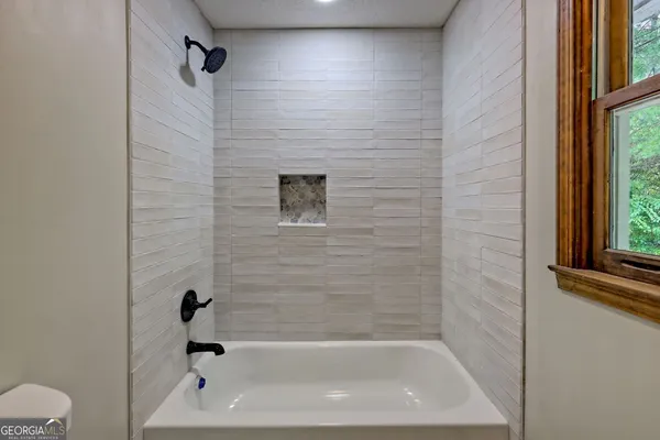 a view of a balcony with wooden floor and fence