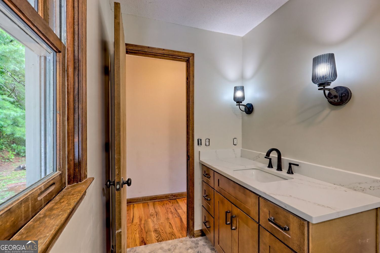 156 Tahoe Lane Dillard, GA 30537 - Photo 38 of 76 a bathroom with a sink a light fixture and a mirror