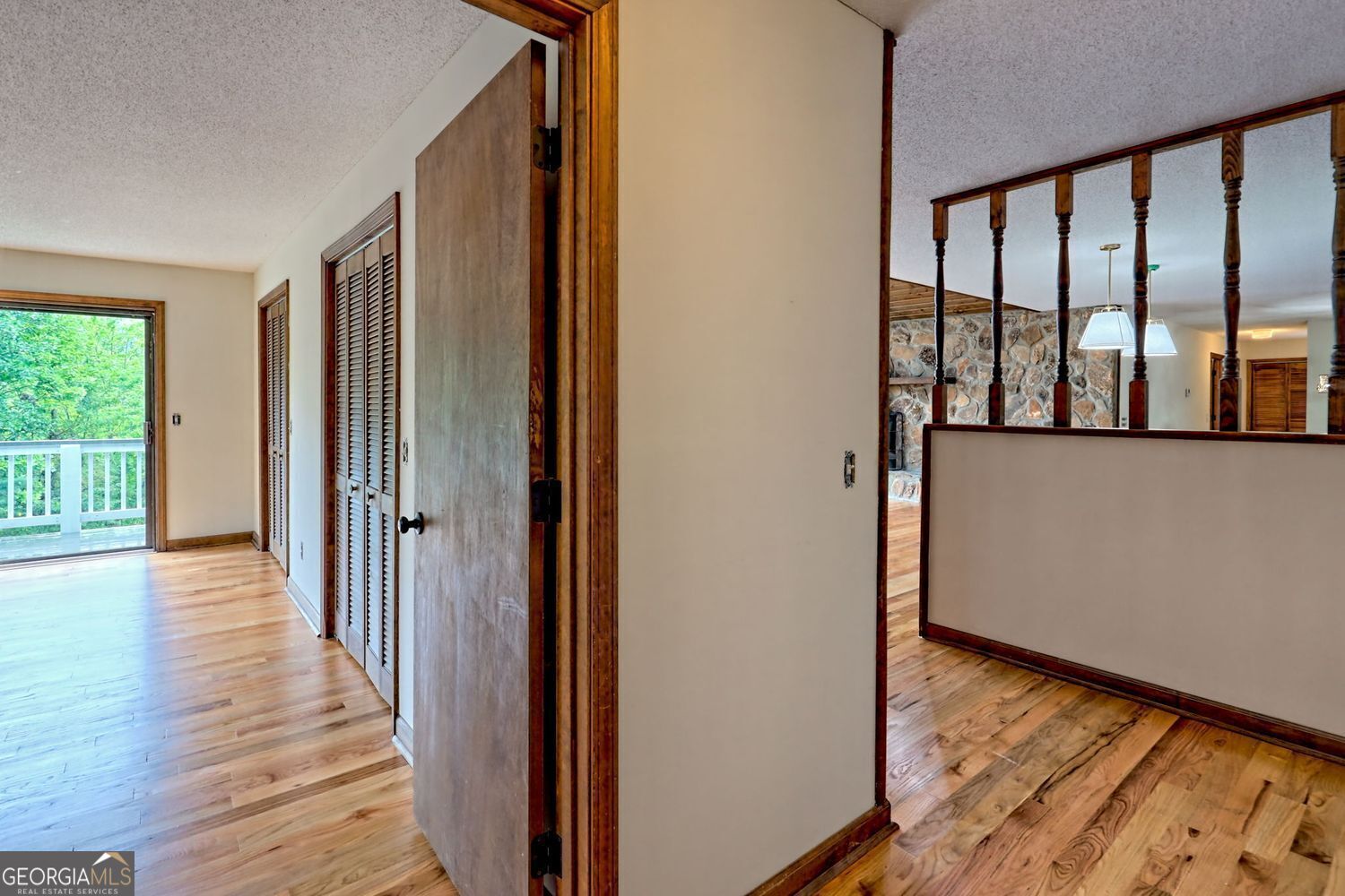 156 Tahoe Lane Dillard, GA 30537 - Photo 44 of 76 a view of a hallway with wooden floor and staircase