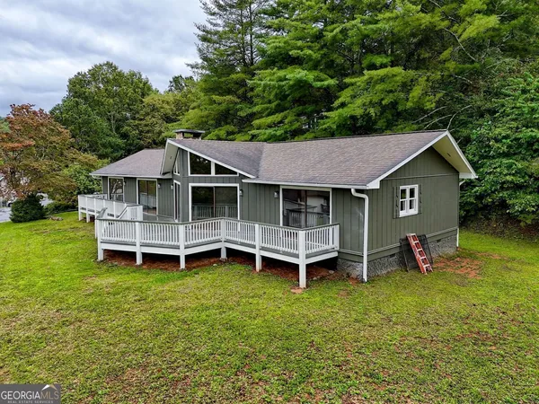 an aerial view of a house with a garden and deck