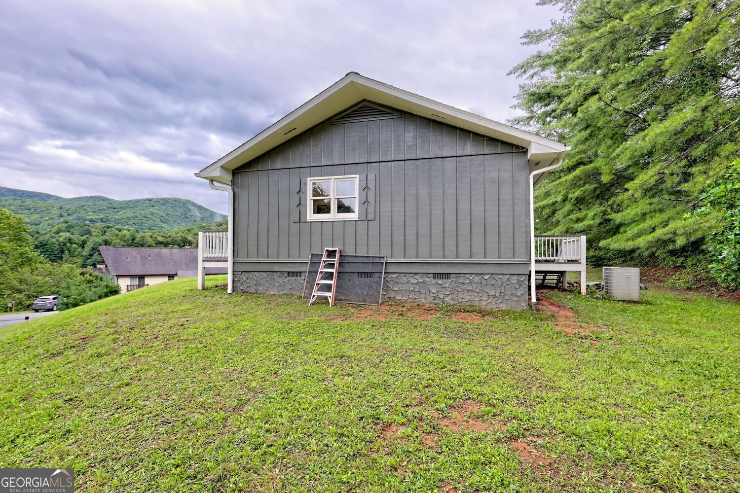 156 Tahoe Lane Dillard, GA 30537 - Photo 68 of 76 a backyard of a house with barbeque oven table and chairs