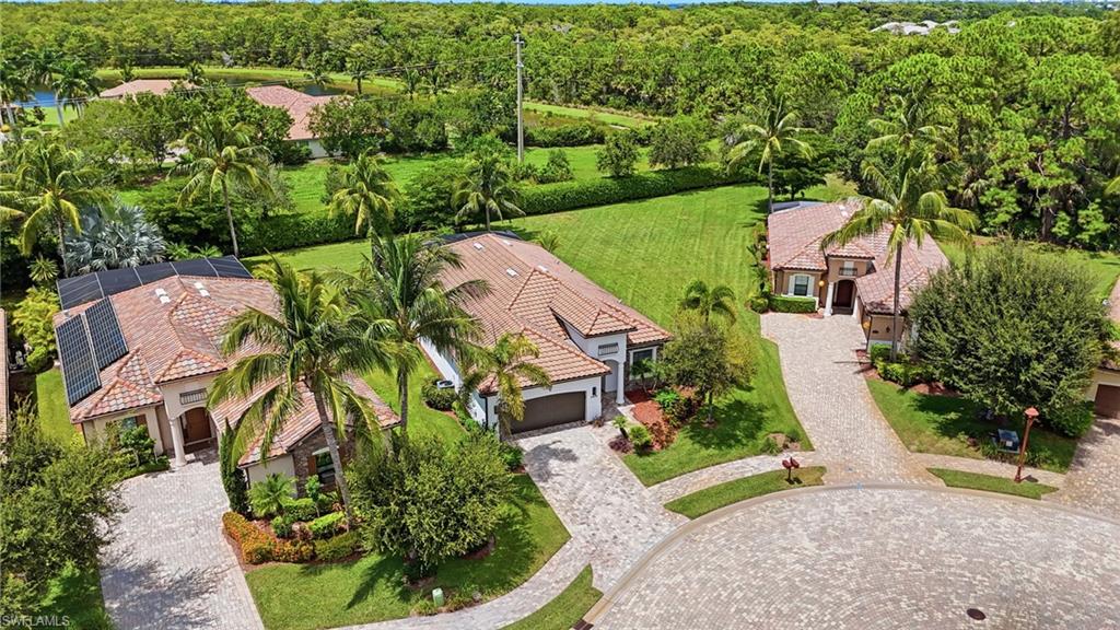 9479 Piacere Way Naples, FL 34113 - Photo 41 of 48 Aerial perspective showcasing properties with tiled roofs, paver driveways, and surrounding green spaces