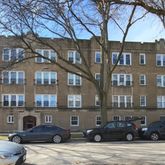 a couple of cars parked in front of a building