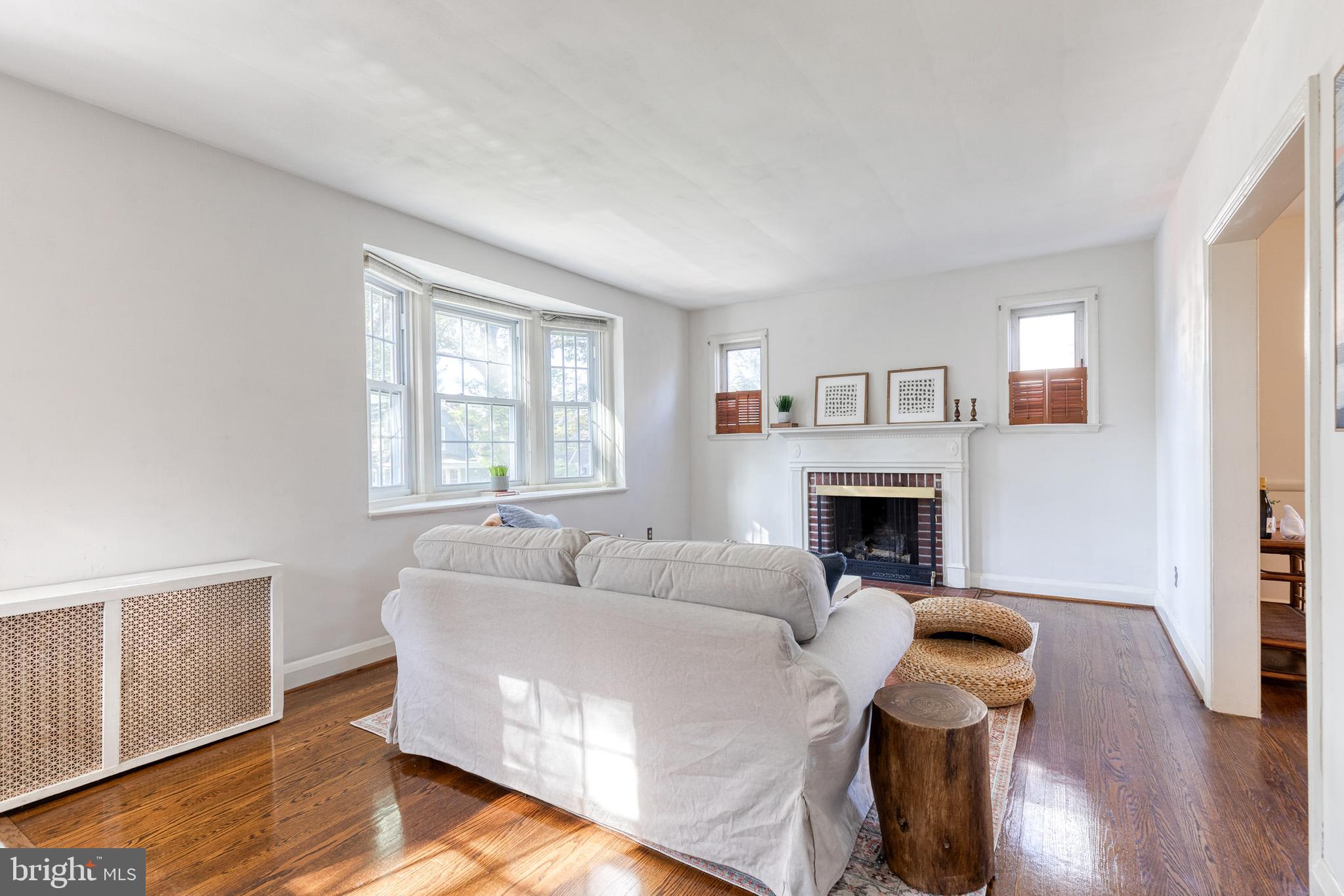 724 Murdock Road Baltimore, MD 21212 - Photo 11 of 42 a living room with furniture a fireplace and a window