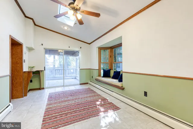 a bedroom with furniture and a large window