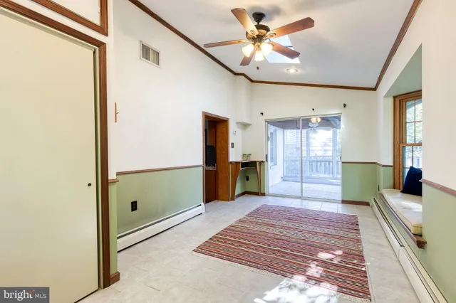 a living room with furniture a flat screen tv and a table
