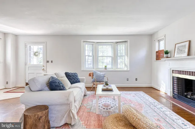 a living room with furniture a fireplace and a window