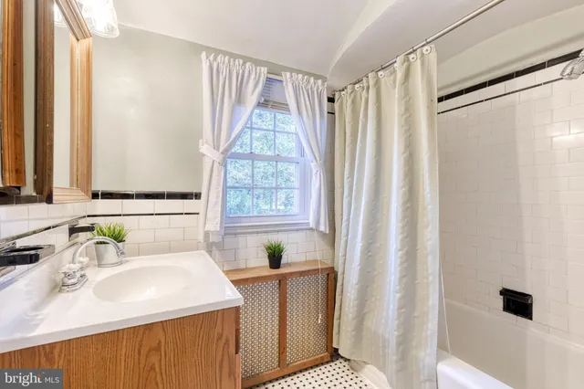 a bathroom with a sink a mirror and a shower