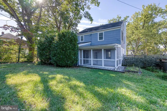a view of backyard of house with green space