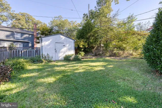a view of a big house with a big yard and large tree