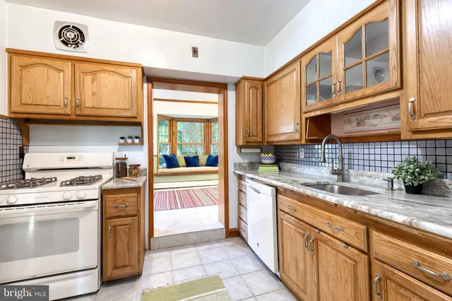 a kitchen with stainless steel appliances granite countertop a stove and a sink