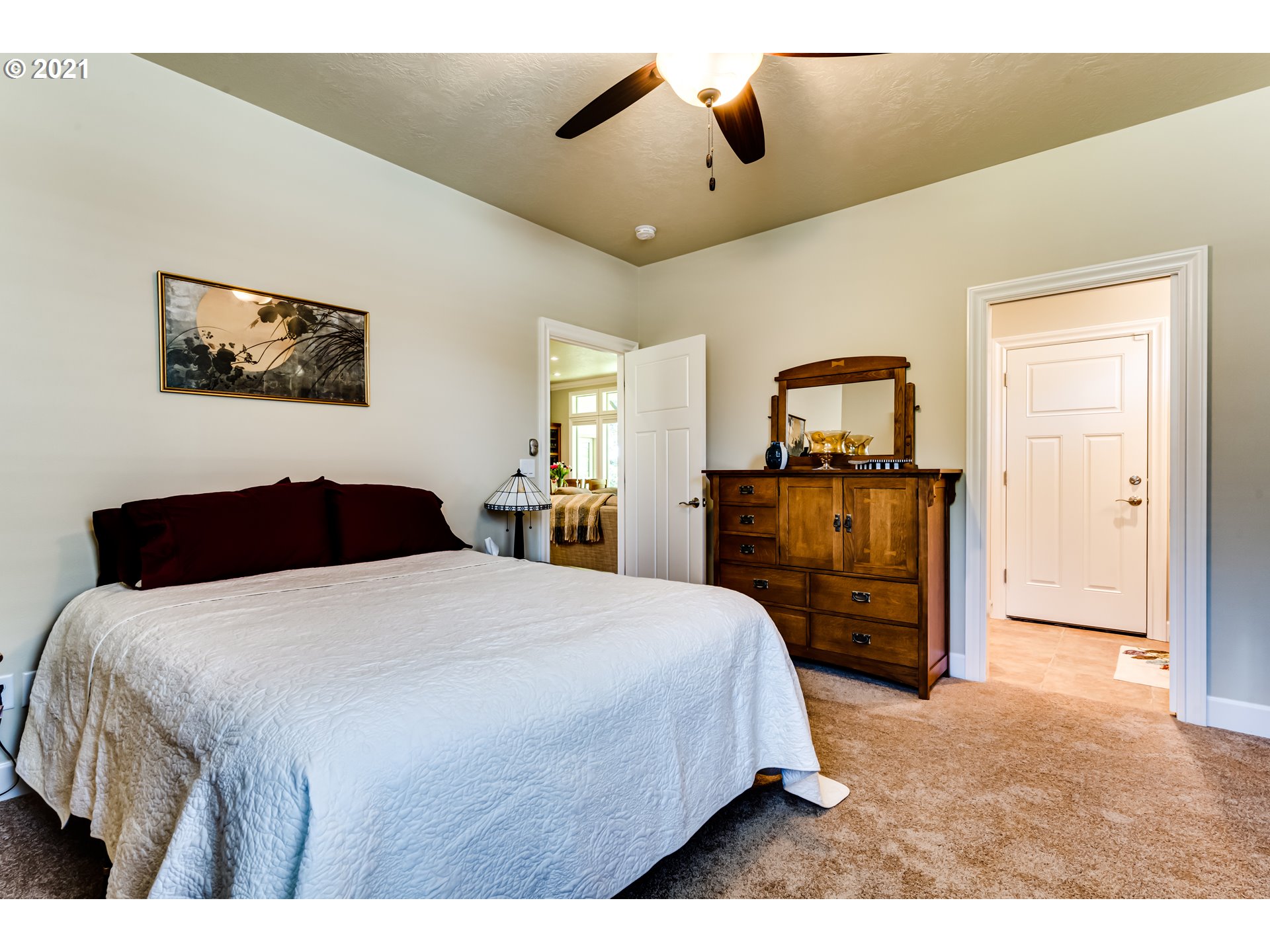 6128 Graystone Loop Springfield, OR 97478 - Photo 17 of 32 a bedroom with a bed and a flat screen tv