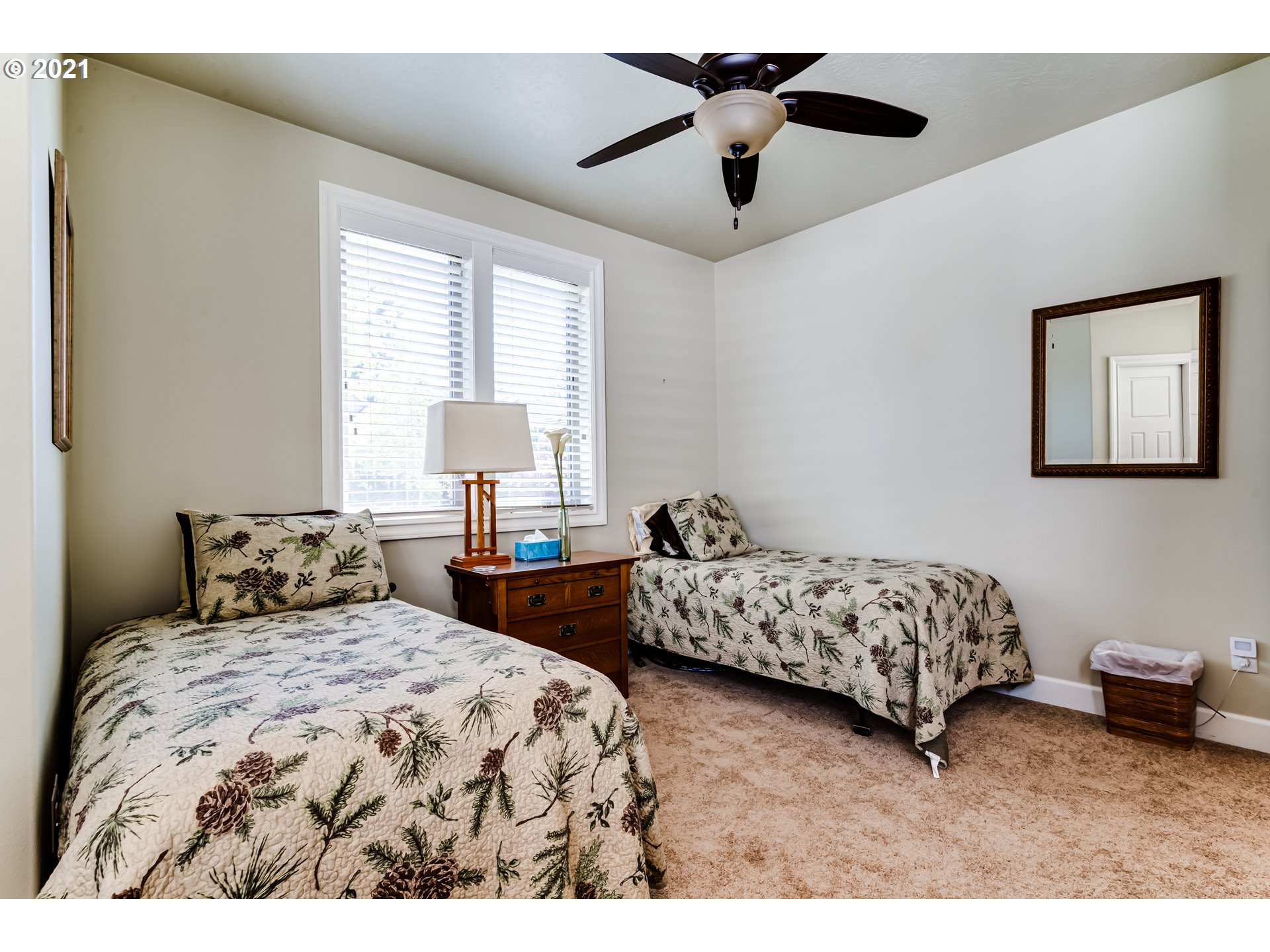 6128 Graystone Loop Springfield, OR 97478 - Photo 18 of 32 a bedroom with two beds and a chandelier