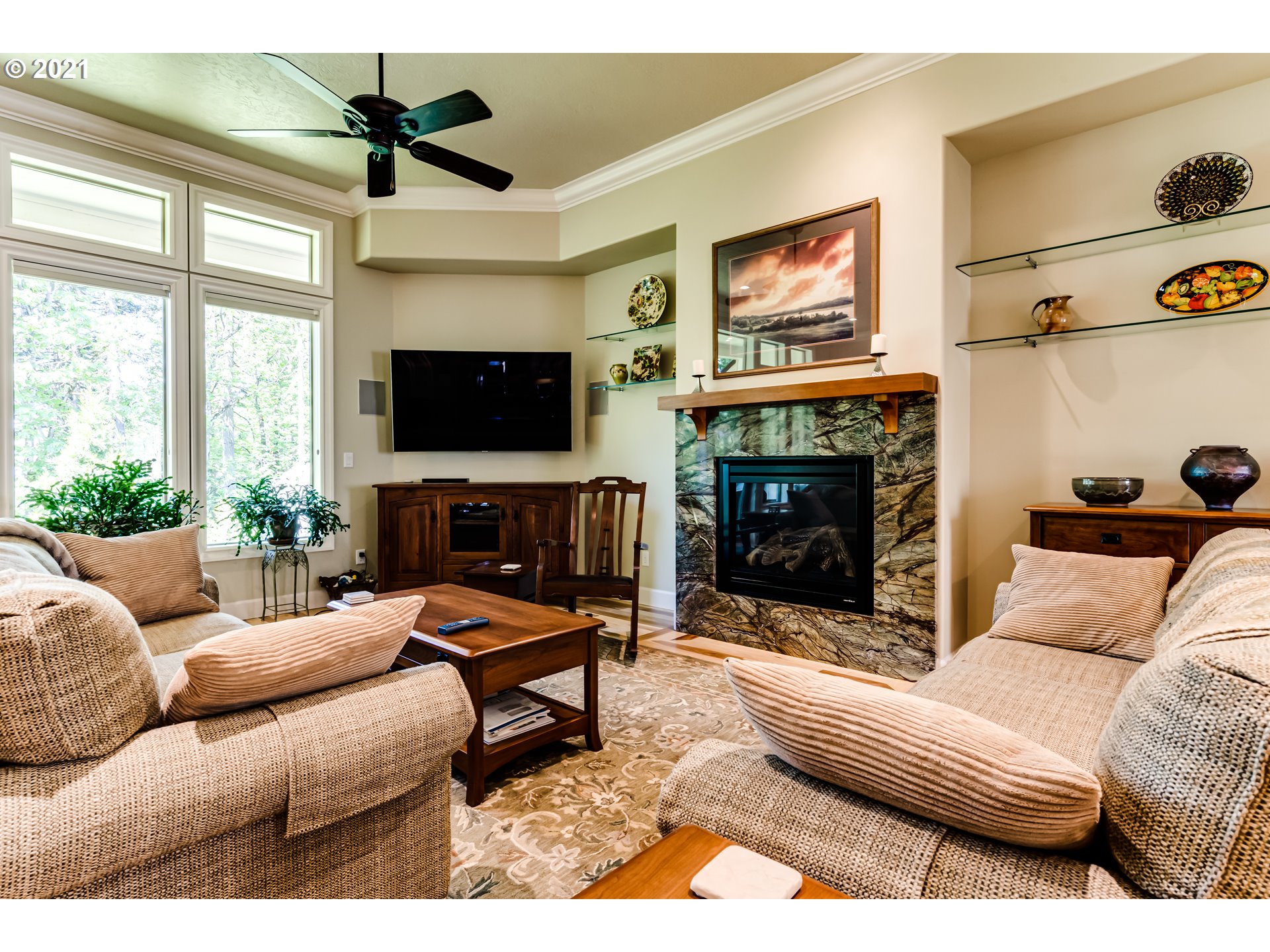 6128 Graystone Loop Springfield, OR 97478 - Photo 3 of 32 a living room with furniture a fireplace and a flat screen tv