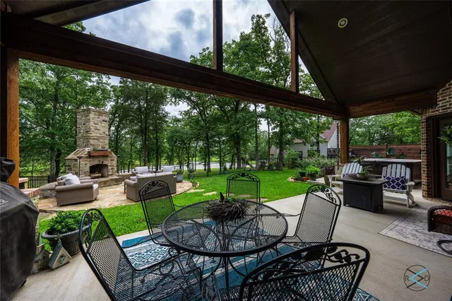 a view of a patio with couches chairs and a yard