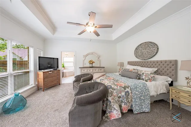 a bedroom with bed and a flat screen tv