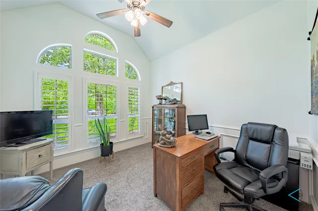 a view of a livingroom with workspace and a window